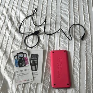 Texas Instruments Pink TI-84 Calculator with charger and instructions